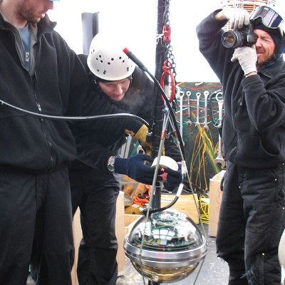 An IceCube digital optical module attached to it’s cable, ready to be lowered 2.4 kilometers into its final location in the South Polar icecap. The sensor electronics were designed and built at Berkeley Lab. (Credit: Spencer Klein, Berkeley Lab)